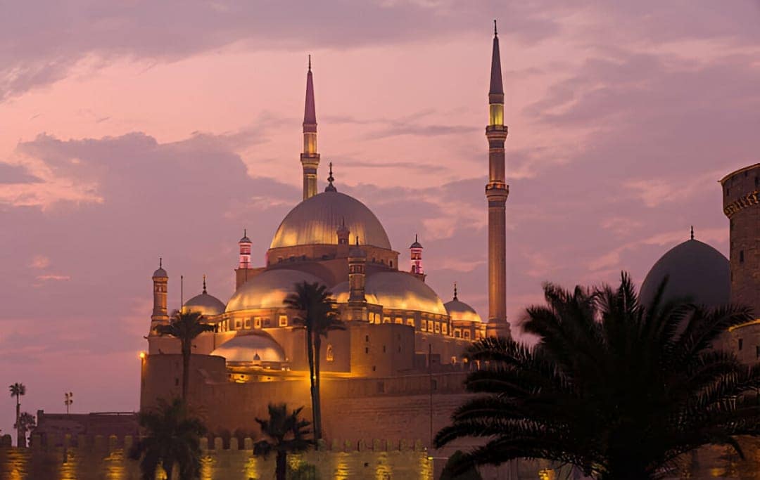 Mosque of Muhammad Ali Saladin Citadel Cairo The Mosque of Muhammad Ali at the Saladin Citadel in Cairo, featuring its twin minarets and Ottoman-style domes illuminated by a pink sunset sky.