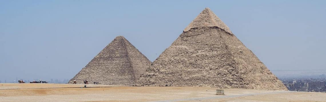 A panoramic view of the Great Pyramids of Giza under a clear blue sky, a key highlight of the private day tours from Hurghada offered by Top Class Egypt Travel.