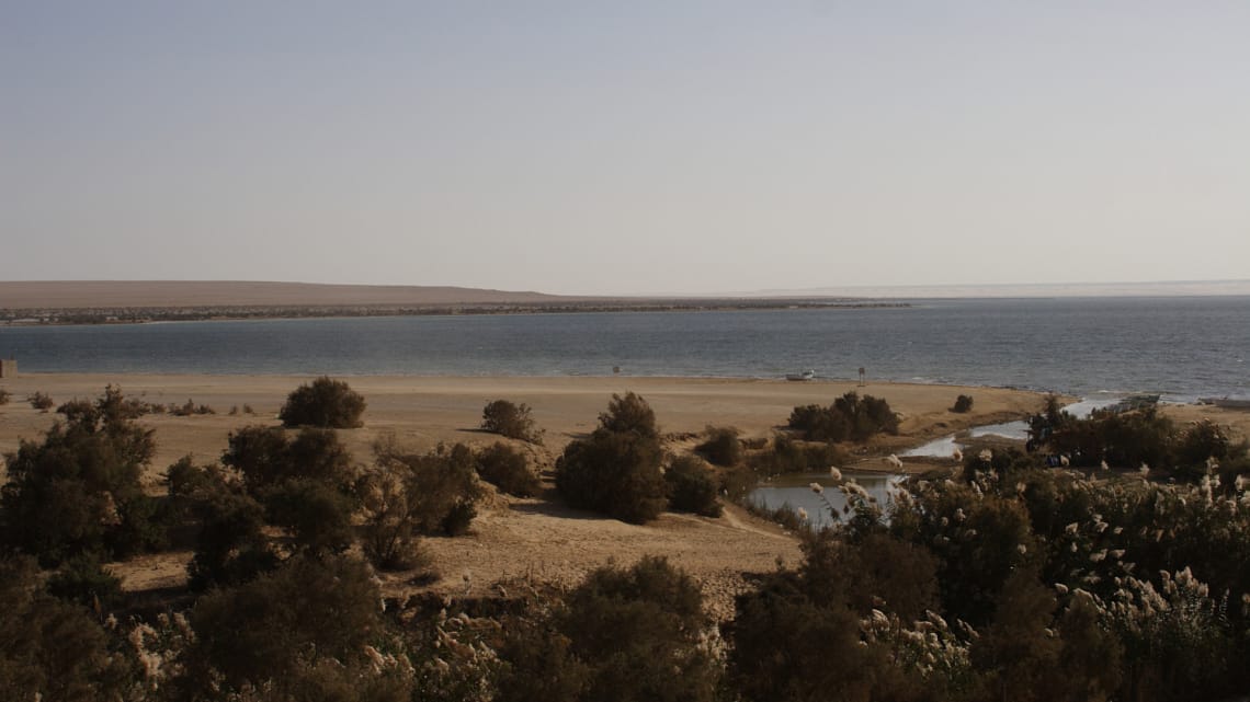 A panoramic view of the historic Qarun Lake surrounded by desert landscape in Fayoum Egypt.