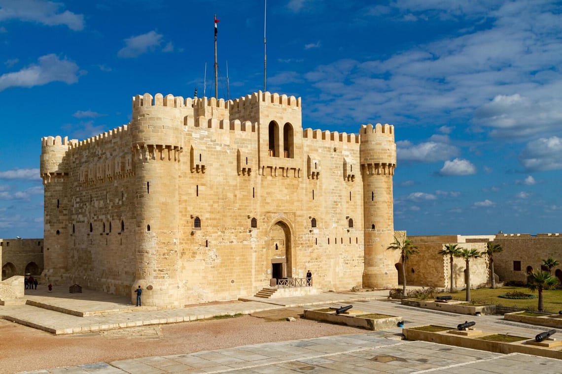 The historic stone walls and fortress of Qaitbay Citadel overlooking the Mediterranean Sea in Alexandria Egypt.