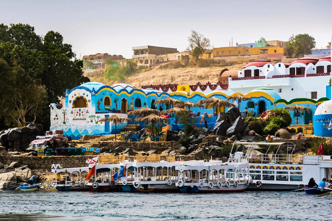 Scenic view of the Nile Ri15 Days Honeymoon Egypt - Scenic view of the Nile Riverver with traditional boats and colorful buildings on the way to the Nubian Village in Aswan