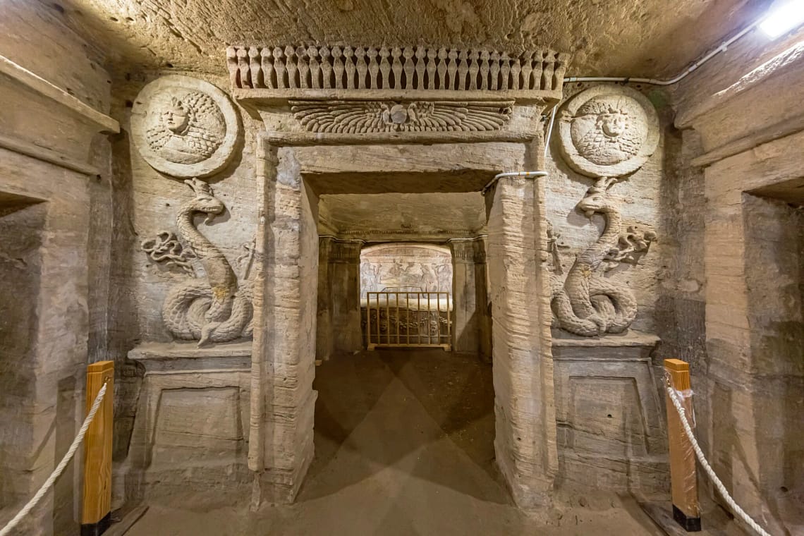 Detailed relief carvings and statue at the entrance of the Tomb of Mereruka in Saqqara