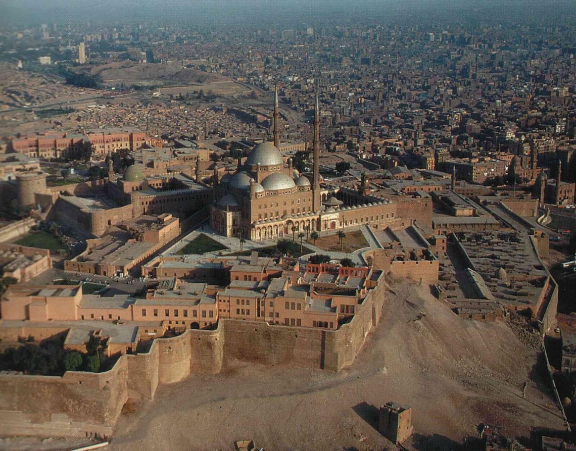 Aerial view of the massive stone walls and historic structures of the Saladin Citadel in Cairo.