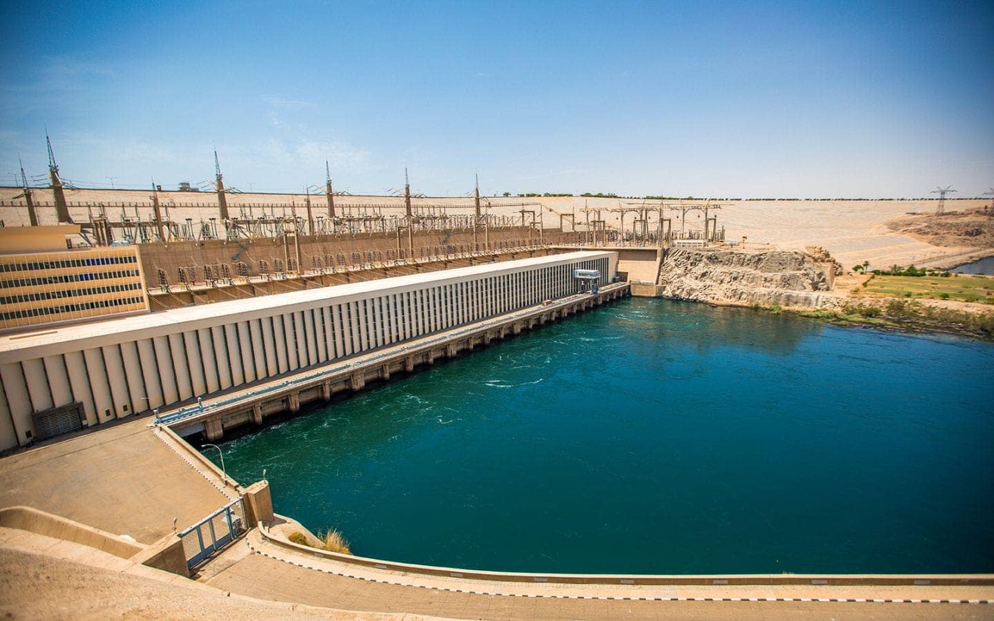 A wide-angle view of the Aswan High Dam and Lake Nasser, showcasing the modern engineering marvel that controls the Nile River in Egypt.