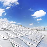 The modern architectural sun disk design of Bibliotheca Alexandrina library under a blue sky in Alexandria Egypt.