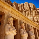 he Osirid statues and limestone colonnades of the Mortuary Temple of Hatshepsut at Deir el-Bahari, Luxor, during a private Top Class Egypt Travel excursion.