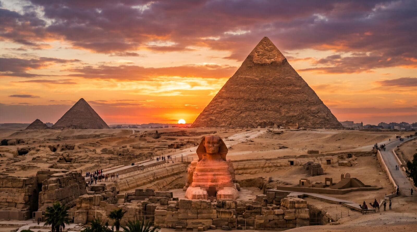 Sunset at the Giza Pyramids and Great Sphinx with orange sky