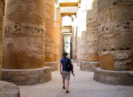 young man walking egyptian temple scaled e1701364168927